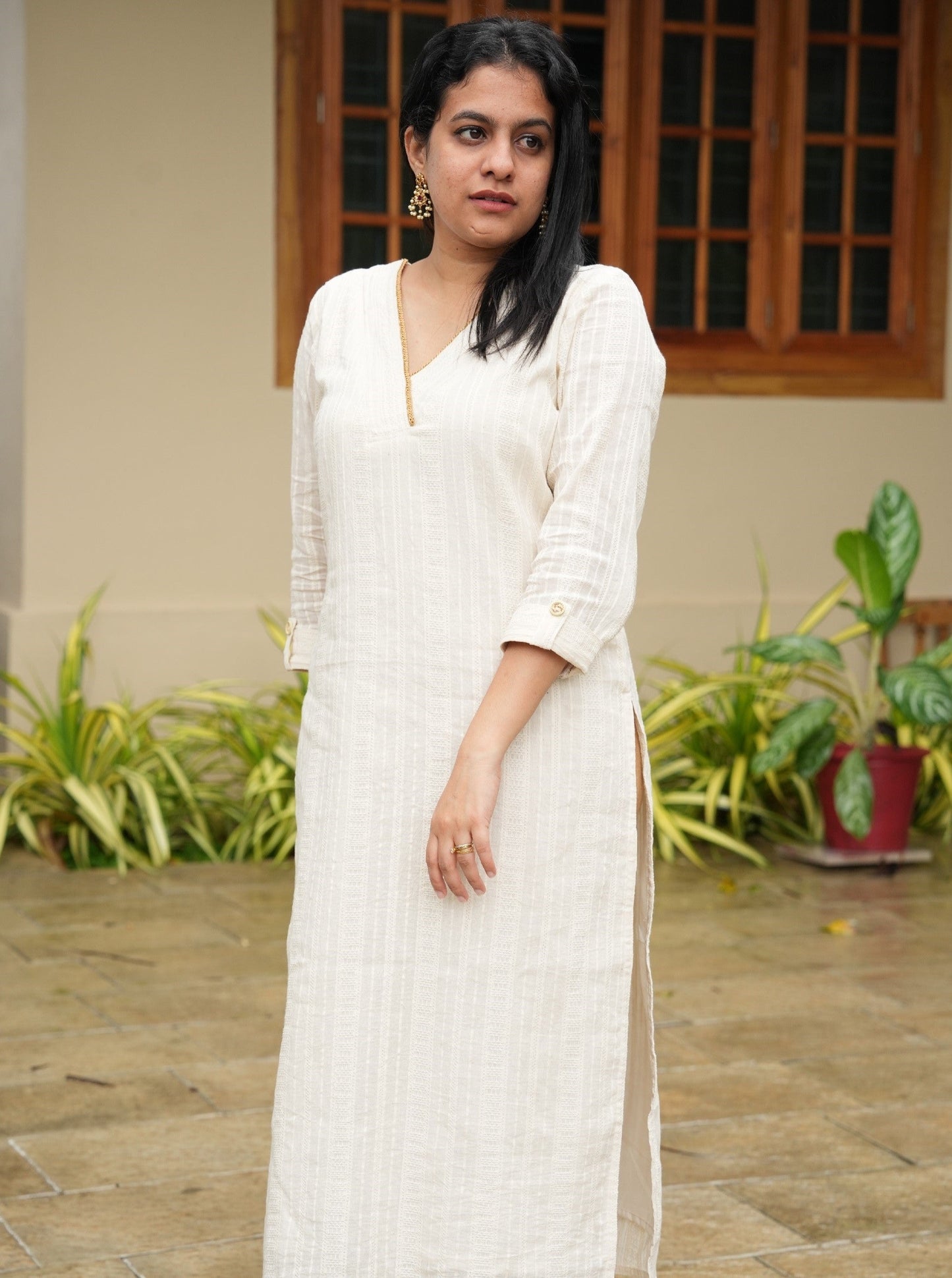 off-white cotton kurti with golden lace detailing on the neck